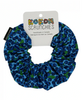 Blue scrunchie with green pattern on a white background, featuring a 'Kokom Scrunchies' label.