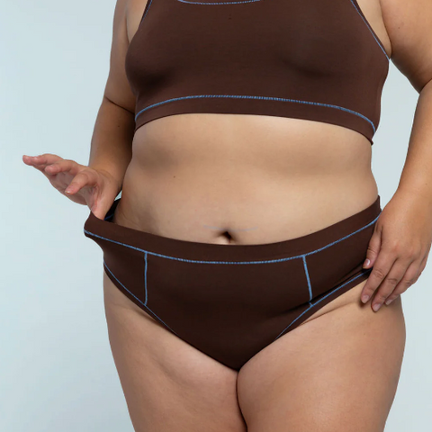 Brown thong with visible branding on a light gray background