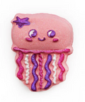 Pink jellyfish-shaped cookie with decorative elements on a white background