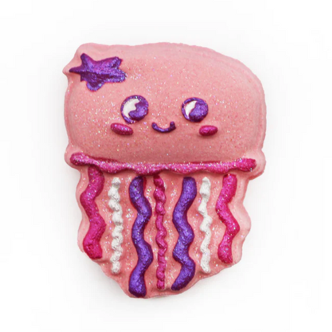 Pink jellyfish-shaped cookie with decorative elements on a white background