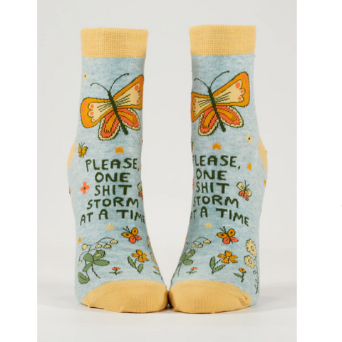 Pair of socks with butterfly design and text on a product page