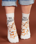 White socks with dog print worn by a person, displayed on a website page.