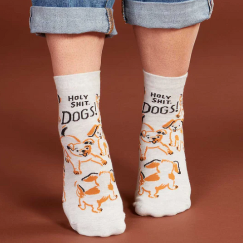 White socks with dog print worn by a person, displayed on a website page.