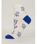 White sock with blue accents and floral designs on a gray background