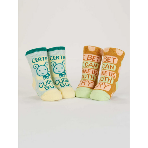 Set of four baby socks with text on a gray background, displayed on an e-commerce website.