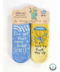 Pair of novelty baby socks with humorous text on a website page.