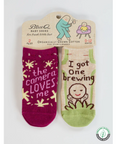 Two baby socks with text on a product page, featuring a brand logo.