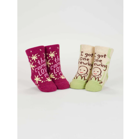 Three pairs of baby socks with text on a white background, displayed on an e-commerce website.