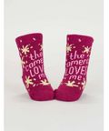 Pair of pink baby socks with text on a white background