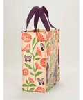 Floral tote bag with purple handles on a product page