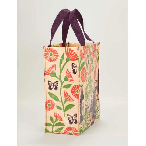 Floral tote bag with purple handles on a product page