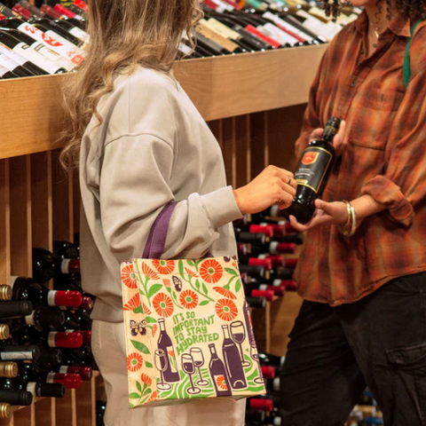 Two women shopping in a store with a product image and price displayed on the screen.