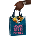 Tote bag with dog illustrations and text held by a hand on a website page.