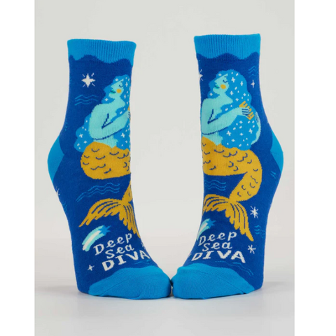 Blue socks with mermaid design labeled 'Deep Sea Diva' on a gray background