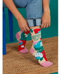 Colorful socks with text being worn by a person on a website page.
