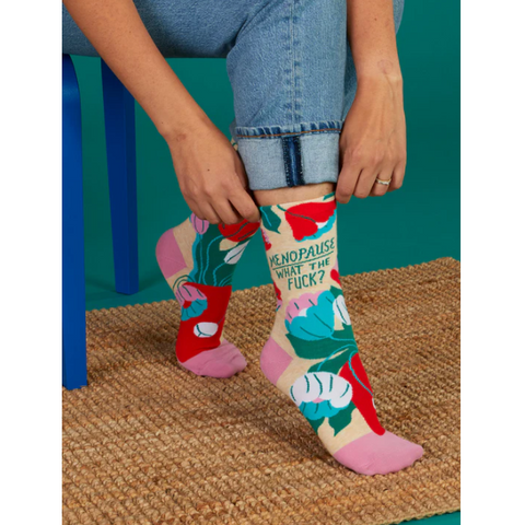 Colorful socks with text being worn by a person on a website page.