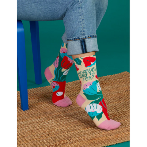Colorful socks with floral patterns and text on a product page.