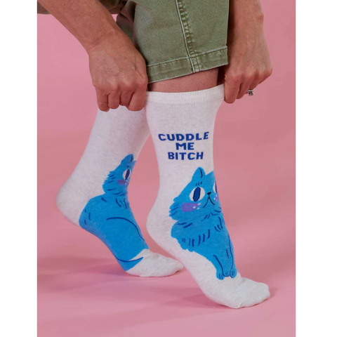 White socks with blue cat design and text on a pink background