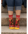 Red and yellow patterned socks with text on a product page