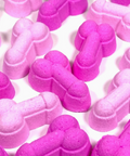 Pink and purple dog bone-shaped bath bombs on a white background