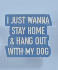 Sticker with text 'I just wanna stay home & hang out with my dog' on a light blue background