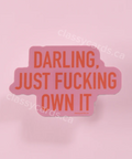 Pink card with red text 'Darling, just fucking own it' on a pink background