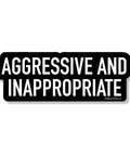Black rectangular sign with white text 'AGGRESSIVE AND INAPPROPRIATE' on a white background