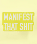 Yellow product with 'MANIFEST THAT SHIT' text on a white background