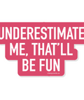 Pink and white sign with text 'UNDERESTIMATE ME, THAT'LL BE FUN' on a white background
