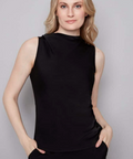 Woman wearing a black sleeveless top against a gray background