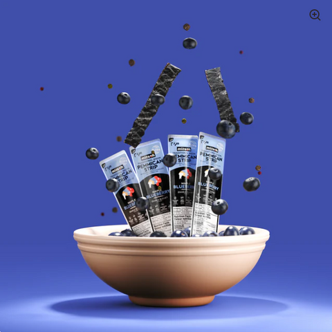 Bowl with blueberry packages and blueberries against a blue background