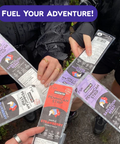People holding packages of 'Mitsch' food strips with promotional text 'Fuel Your Adventure!'