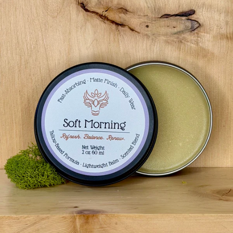 Two tins of 'Soft Morning' balm on a wooden surface