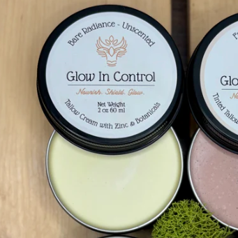 Six containers of 'Glow In Control' cream on a wooden surface with a website interface overlay.