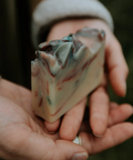 Hand holding a piece of multicolored soap