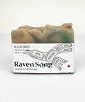 Bar of soap with 'Raven Song' packaging on a white background