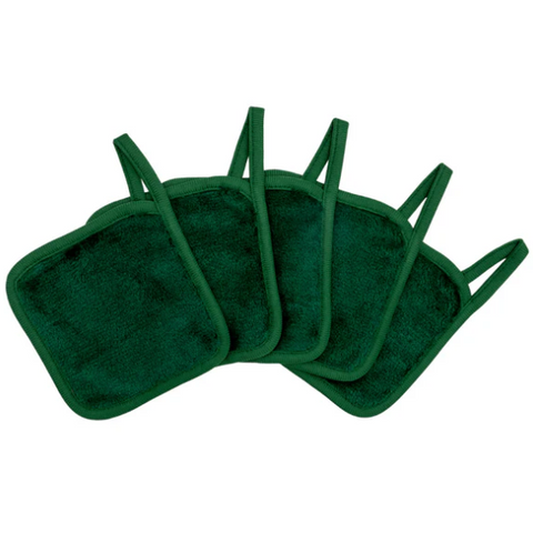 Set of green makeup remover pads on a white background