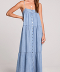 Woman wearing a denim dress against a plain background