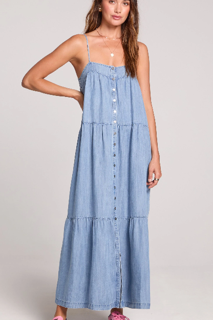 Woman wearing a denim dress against a plain background