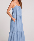 Woman wearing a light blue dress against a plain background