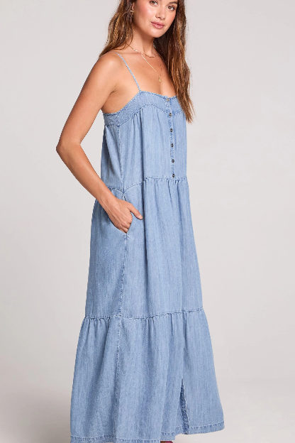 Woman wearing a light blue dress against a plain background