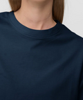 Navy blue t-shirt worn by a person on a white background