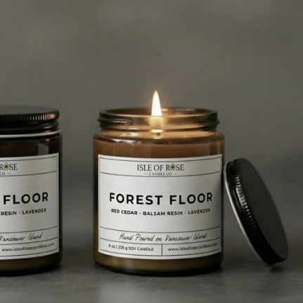 Two candles labeled 'Forest Floor' on a website homepage.