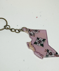 Keychain shaped like the state of British Columbia with floral design on a white background