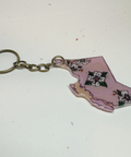 Keychain shaped like the state of British Columbia with floral design on a white background