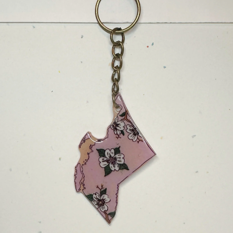 Keychain shaped like a stylized map of British Columbia on a light background