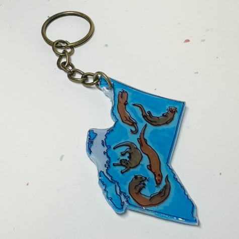 Keychain shaped like the state of British Columbia with blue and brown design on a white background
