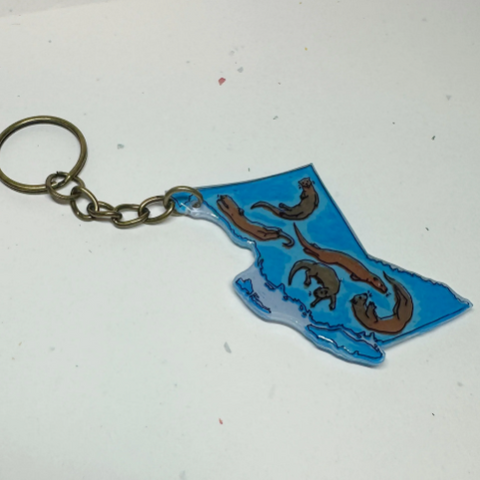 Keychain shaped like the outline of British Columbia with a dragon design on a white background