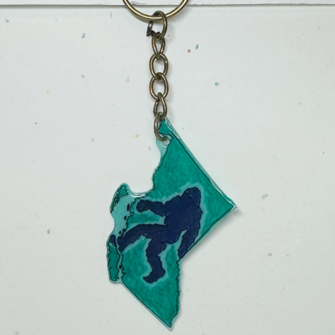 Keychain with teal and navy design on a white background
