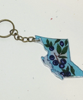 Keychain shaped like the state of British Columbia with floral design on a white background